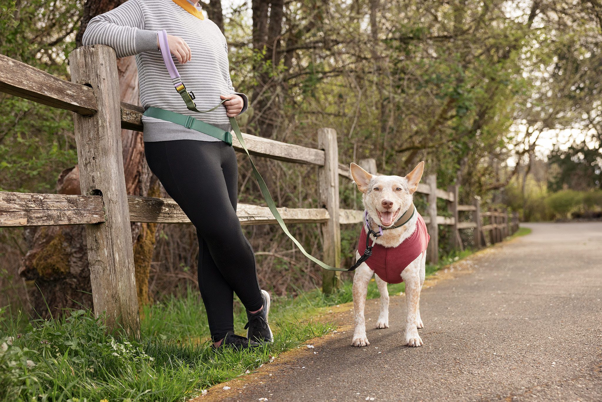 woman leaning on fence with cattle dog wearing goldpaw fleece