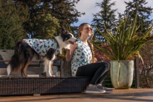 woman and dog in matching sun tees