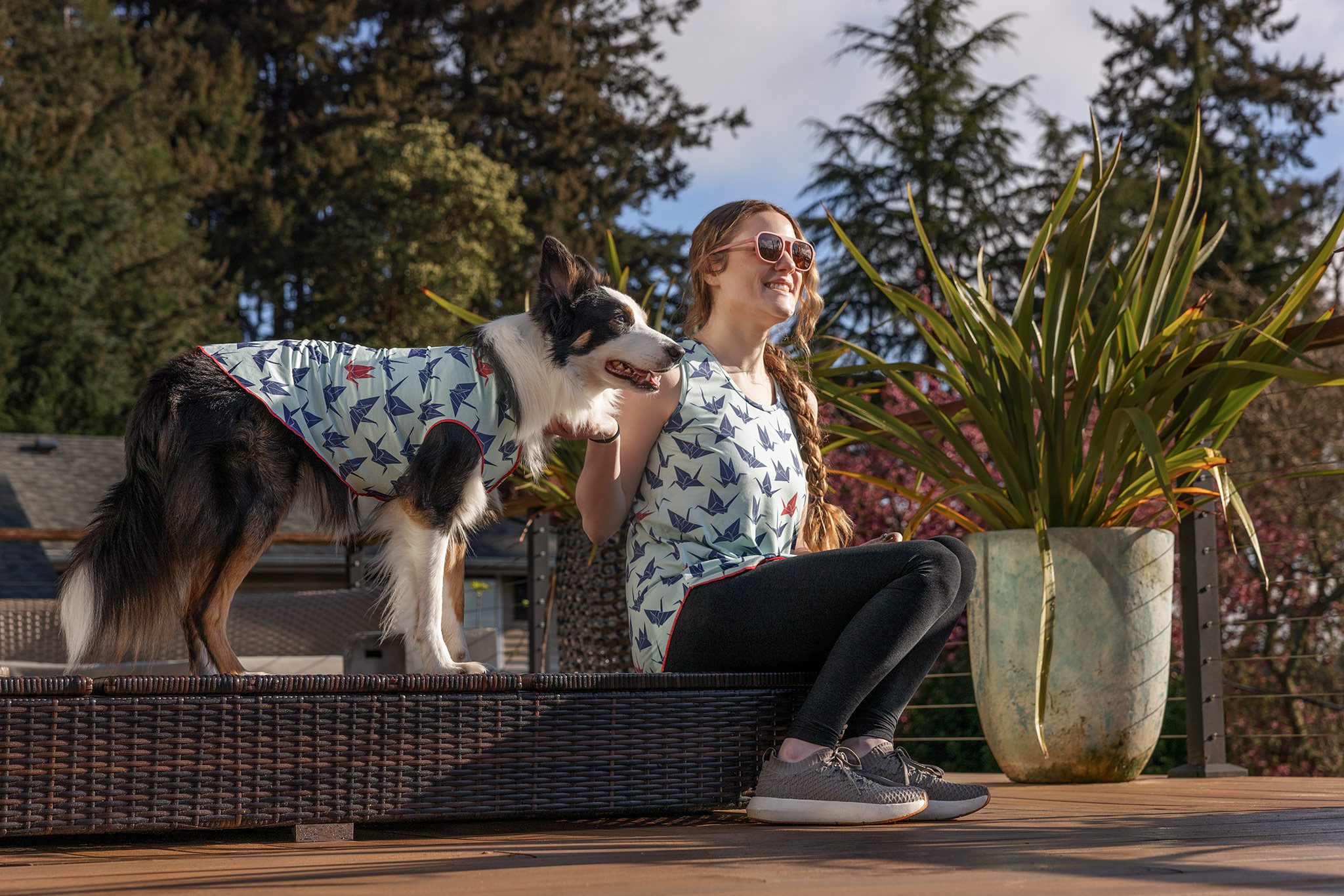 woman and dog in matching sun tees
